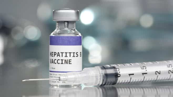 Hepatitis B vaccine vial in medical lab with syringe